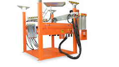 Orange industrial machinery with hydraulic components and safety markings