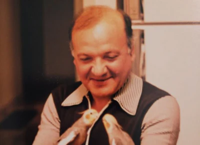 Smiling middle-aged man in striped shirt and dark vest
