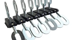 Adjustable metal clamps or clips arranged in a row on a mounting bar