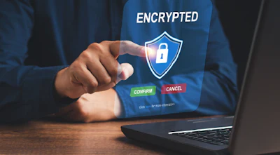 Hand touching encrypted digital security shield on laptop screen