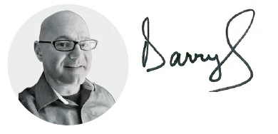 Bald professional wearing glasses in circular black and white portrait