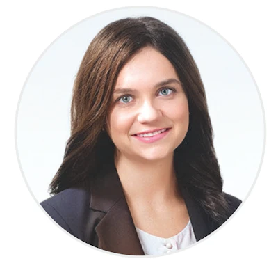 Professional woman in business attire smiling warmly against white background