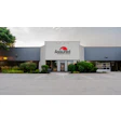 Assured company exterior storefront with red logo on white building