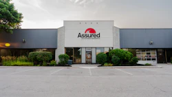 Assured company exterior storefront with red logo on white building