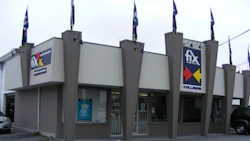 Fix Collision auto repair shop exterior with branded signage and flags
