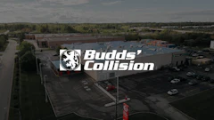 Aerial view of Budds' Collision auto repair shop with logo and parking lot