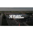 Aerial view of Budds' Collision auto repair shop with logo and parking lot