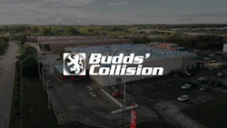 Aerial view of Budds' Collision auto repair shop with logo and parking lot