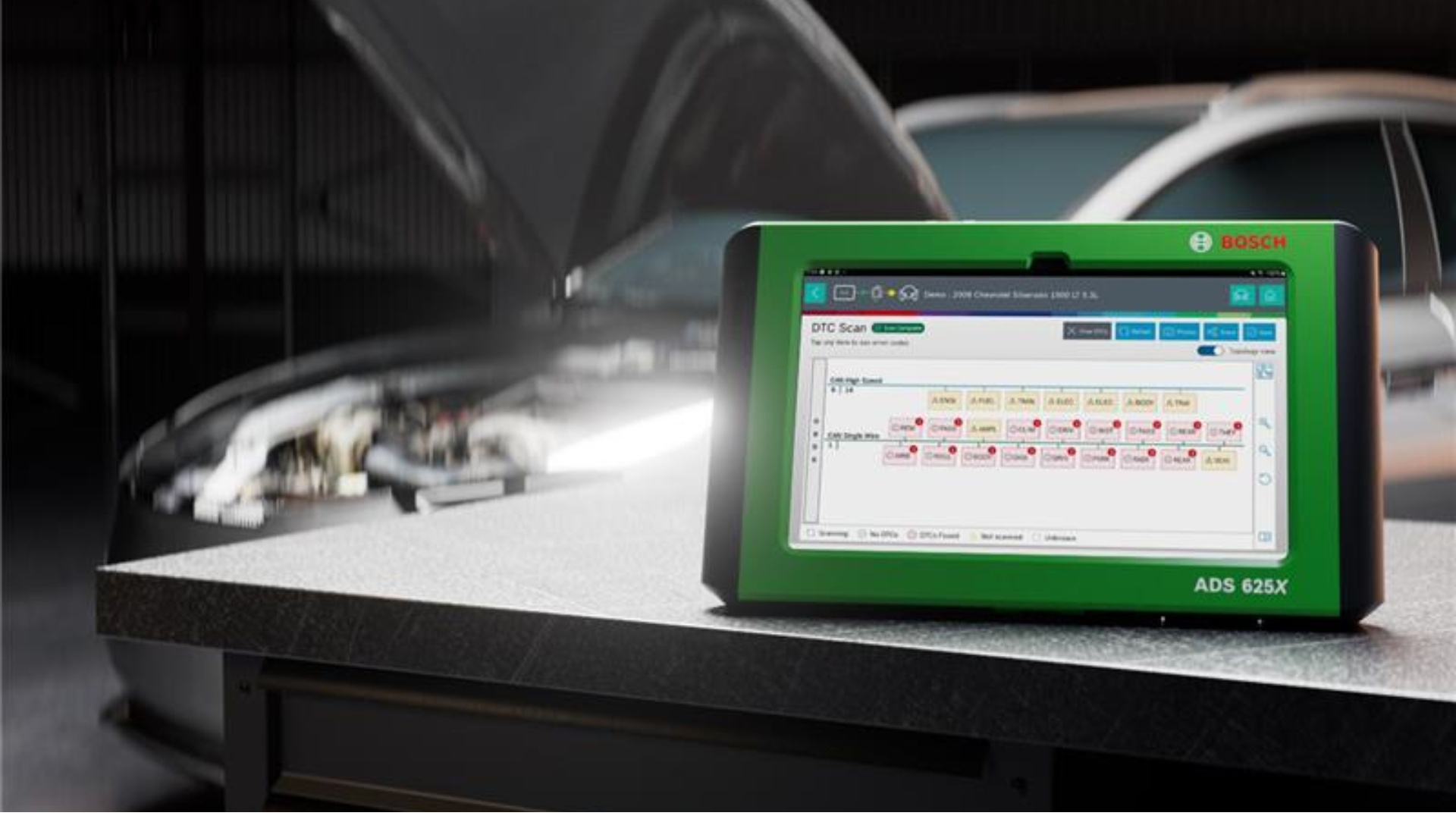 Bosch diagnostic tool ADS 625X on workbench with automotive equipment