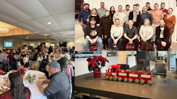 Workplace holiday celebration with team photos, festive decor, and red train display
