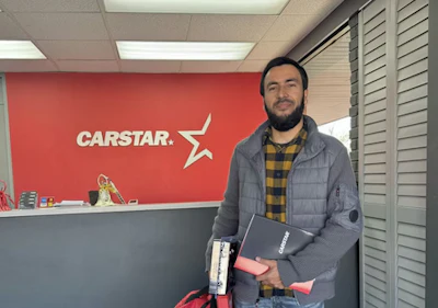 CARSTAR automotive service center reception area with employee