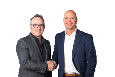 Two businessmen in professional attire shaking hands and smiling