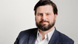 Professional man in blue blazer and white shirt with beard