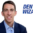 Professional man in blue suit and checkered shirt smiling