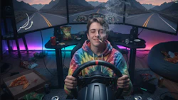 Person in colorful jacket driving simulator with mountain road backdrop