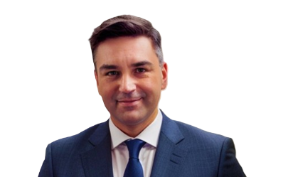 Professional man in navy suit and blue tie smiling against white background
