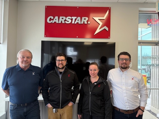 CARSTAR logo with four employees standing in automotive service center