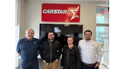 CARSTAR logo with four employees standing in automotive service center