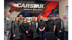 CARSTAR Collision & Glass Service team photo with company logo backdrop