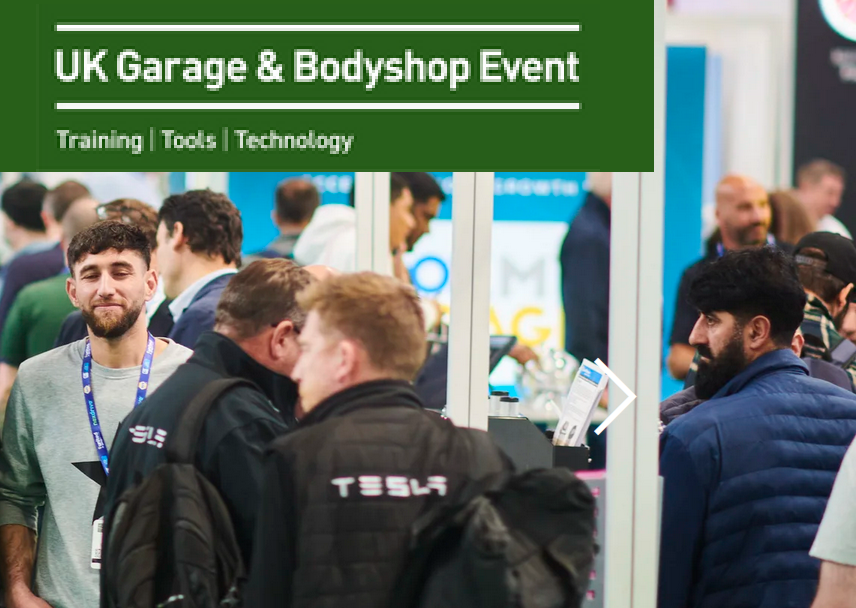 Professionals networking at UK Garage & Bodyshop Event with Tesla staff