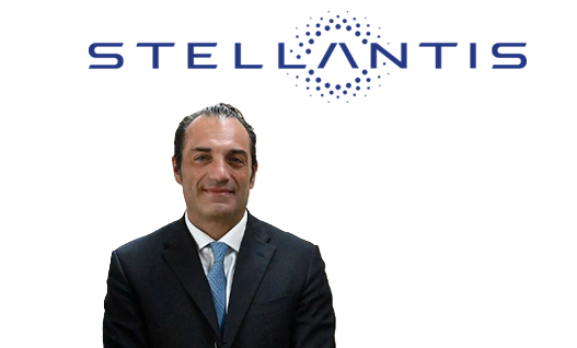 Professional headshot of male executive in dark suit with blue tie, Stellantis logo visible above