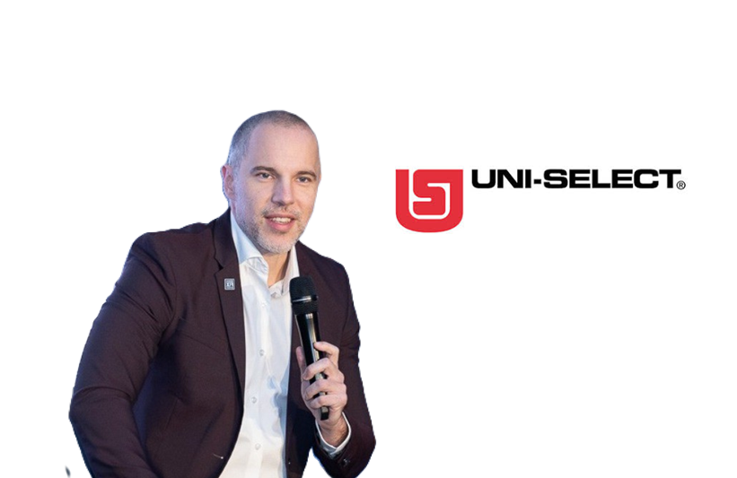 Uni-Select corporate logo with speaker presenting at event