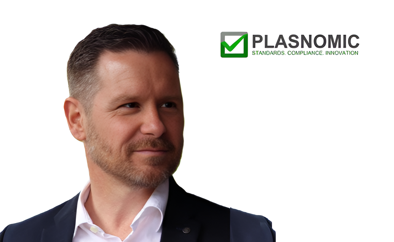 Professional man in business attire with Plasnomic standards compliance innovation logo