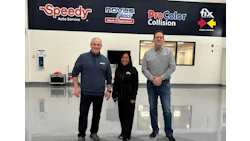 Three professionals standing in automotive service center with Speedy, Novus, ProColor, and Fix Auto logos