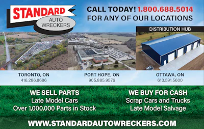 Standard Auto Wreckers logo with distribution hub and vehicle salvage yard aerial view