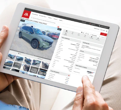 Tablet screen showing online car listing for green SUV with vehicle details