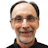 Smiling middle-aged man with glasses wearing black shirt Headshot