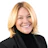 Smiling blonde woman in black turtleneck against white background Headshot