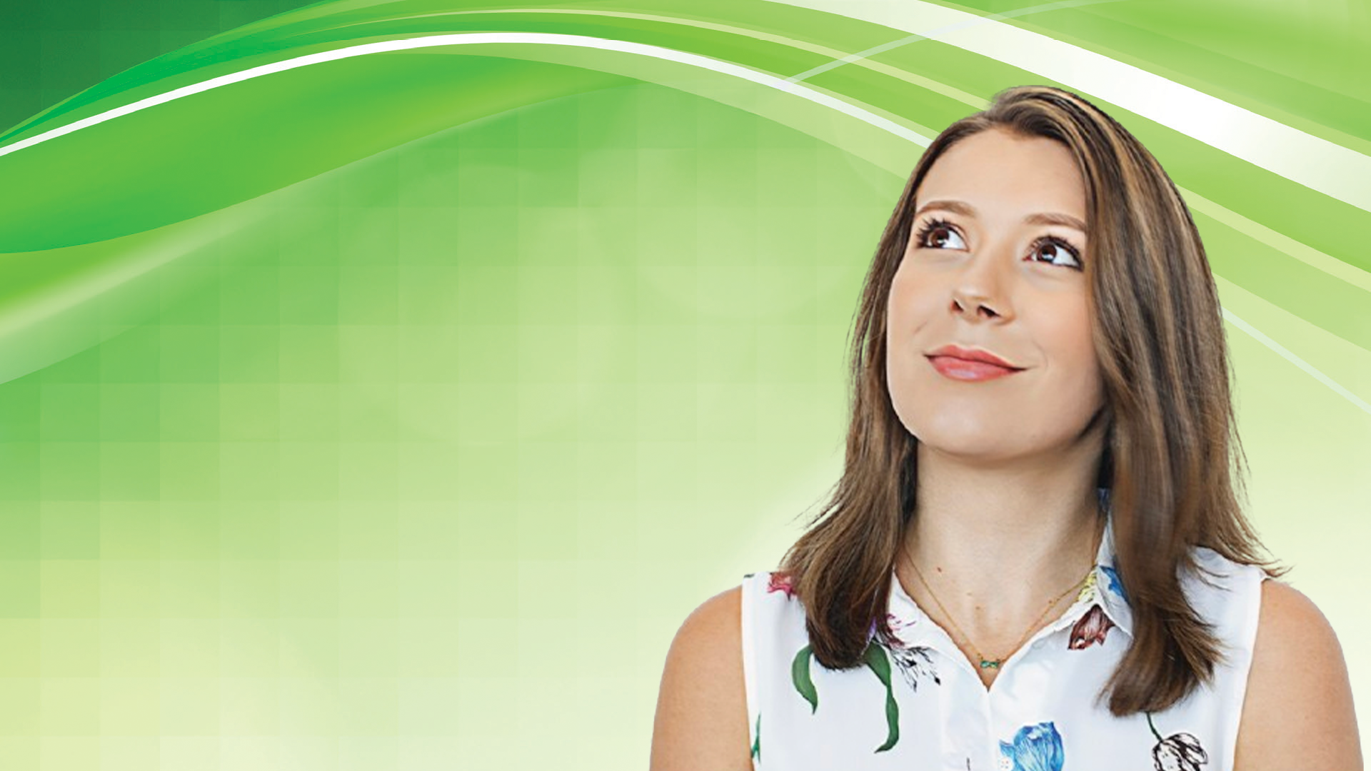 Professional woman in floral sleeveless top looking upward on green background
