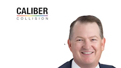 Caliber Collision executive headshot - professional man in navy jacket smiling