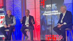 Three professionals participate in a panel discussion at IBIS conference event with 'Connecting Changemakers' branding backdrop.