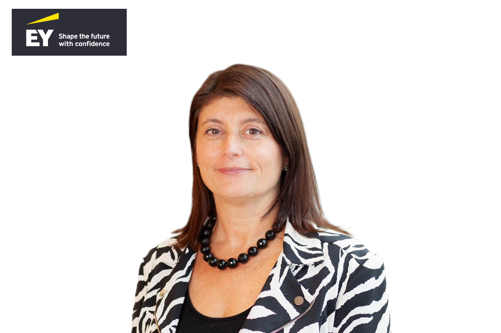 Professional woman with long brown hair wearing a zebra-patterned blazer and black beaded necklace, with EY company logo displayed