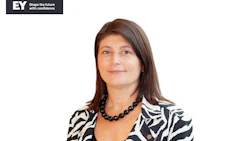 Professional woman with long brown hair wearing a zebra-patterned blazer and black beaded necklace, with EY company logo displayed