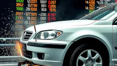 White Geely vehicle with dynamic impact effects and financial market data overlay