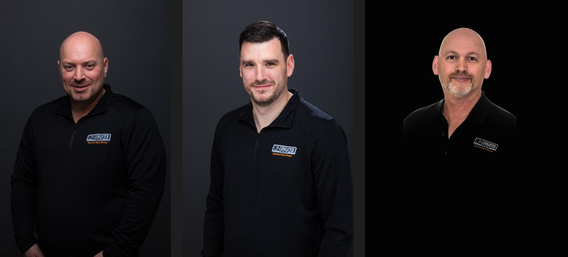 Three professional men in black polo shirts with company logos, posed against neutral backgrounds for a team portrait