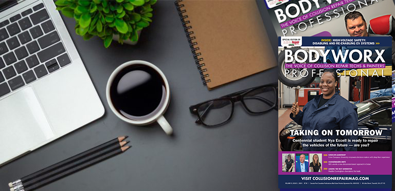 Workspace desk setup with laptop, coffee cup, notebook, and BODYWORX Professional magazine