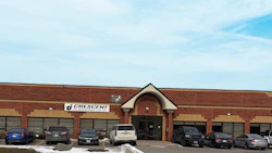 Crescent automotive service facility with red brick exterior, multiple garage bays, and parked vehicles in front