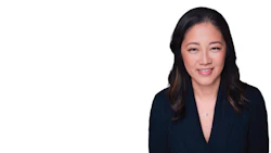 Professional headshot of an Asian woman in dark blazer smiling at camera