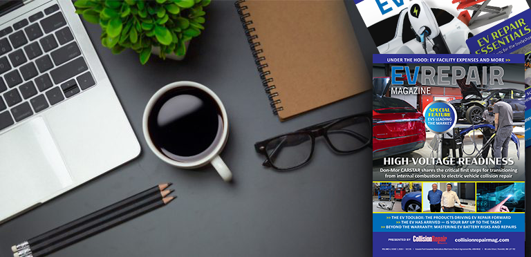 EV Repair Magazine cover on desk with laptop, coffee, notebook, and office supplies