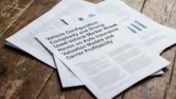 Business documents with vehicle configuration and insurance information spread on wooden surface