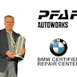 Professional man in suit holding award with PFAFF Autoworks and BMW Certified Repair Center logos