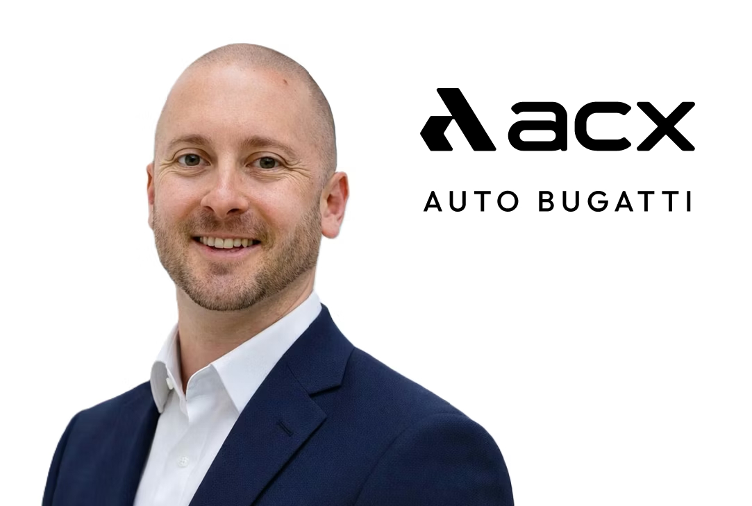Professional headshot of male executive in navy blazer with acx Auto Bugatti branding