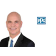 Professional headshot of smiling businessman in dark suit with blue tie, alongside PPG Industries logo