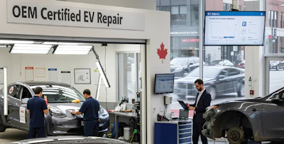 OEM Certified EV Repair shop interior with technicians servicing vehicles and service desk