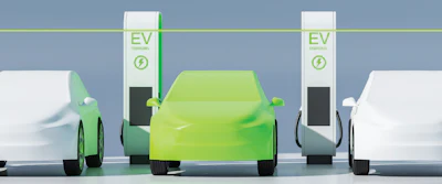 Electric vehicles charging at EV stations with lime green charging posts and white cars in a modern parking facility