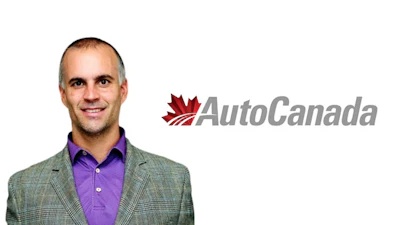 Professional man in gray blazer and purple shirt next to AutoCanada logo with red maple leaf
